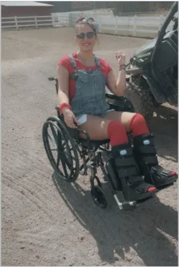 Jaydeen-Lillethorup-in-a-wheelchair-with-boot-casts-on-legs